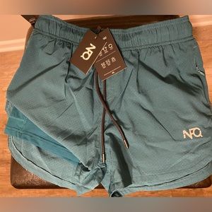 NFQ Women’s Teal Laser Cut Training Shorts. Built in Liner. Size Medium.